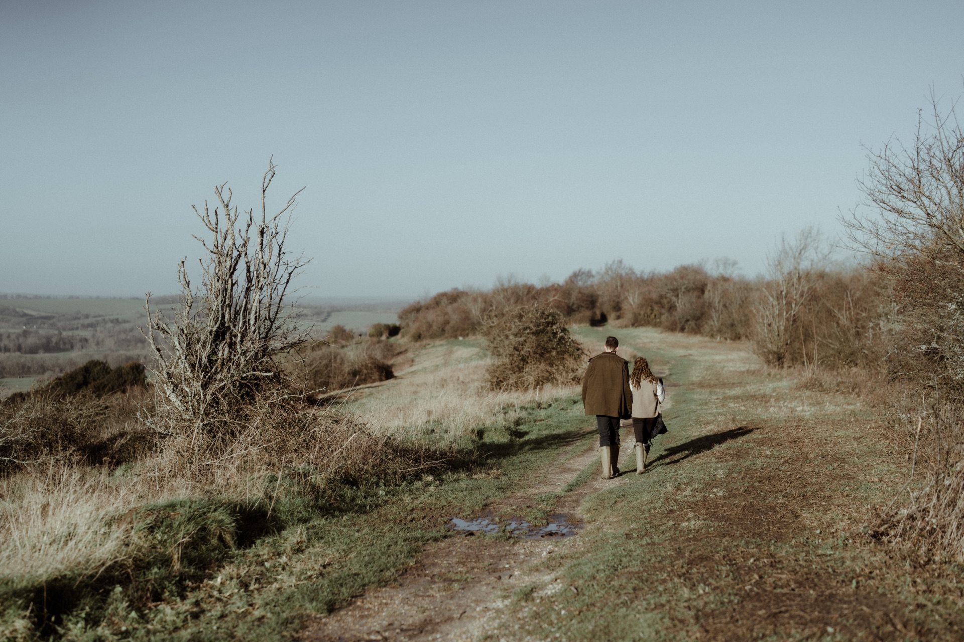 Vere and Ella walking away along a ridge path